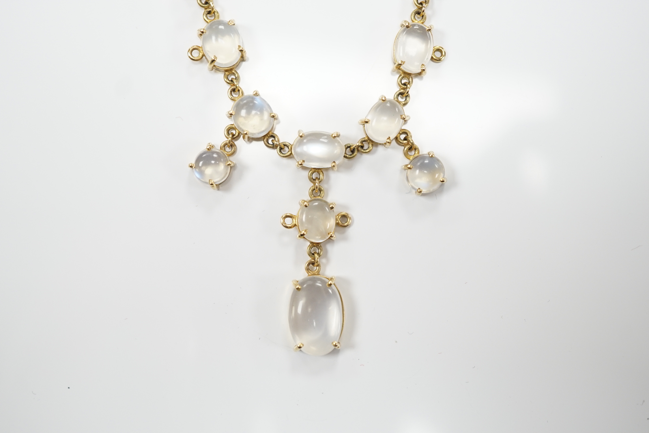 An Edwardian style 9k and cabochon moonstone cluster set drop necklace, 48cm, gross weight 11.2 grams.